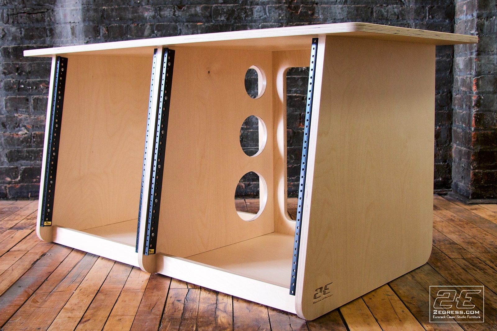 Double Bay Rack | 12U, natural birch finish, angled three-quarter view highlighting the circular cable-pass cutouts | 2Egress
