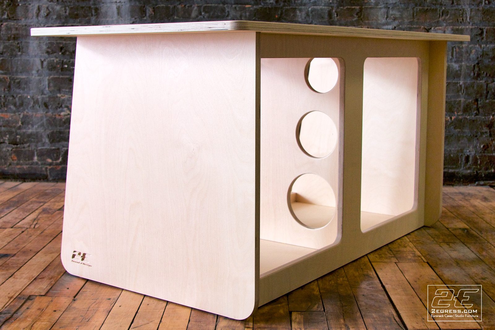 Double Bay Rack | 12U, natural birch finish, side angled view of the cable-pass cutouts with the 2Egress maker's mark | 2Egress