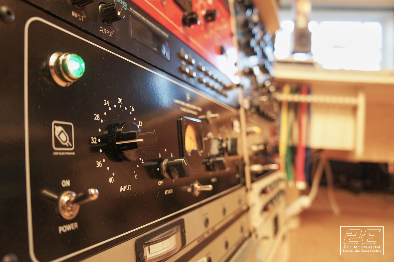 Double Bay Rack | in Damian Taylor's studio, close-up of rack-mounted outboard gear with a glowing green LED | 2Egress