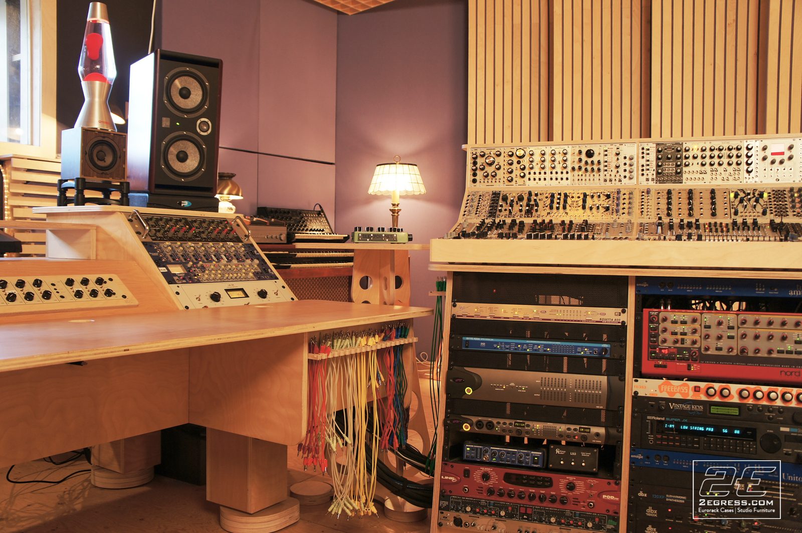 Double Bay Rack | in Damian Taylor's studio, wide view of the modular synth wall and desk under warm lighting | 2Egress