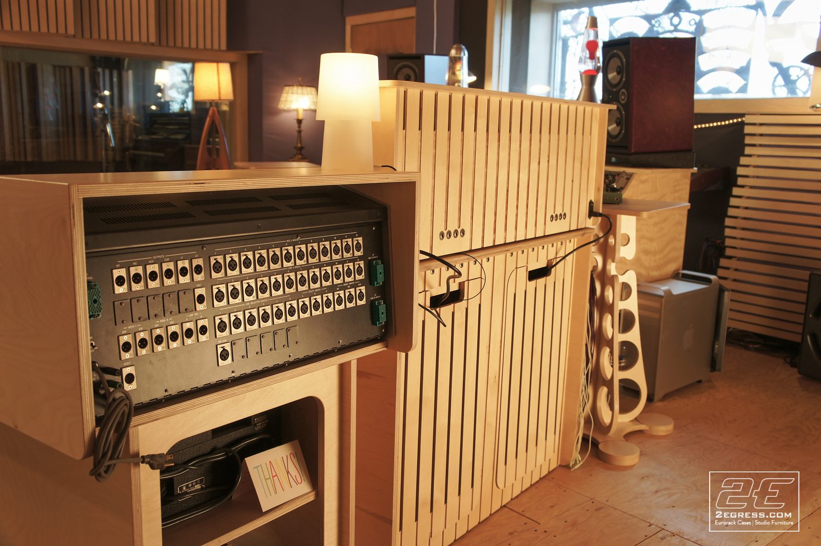 Double Bay Rack | in Damian Taylor's studio, rear patchbay panel open beside a slat-front cabinet | 2Egress