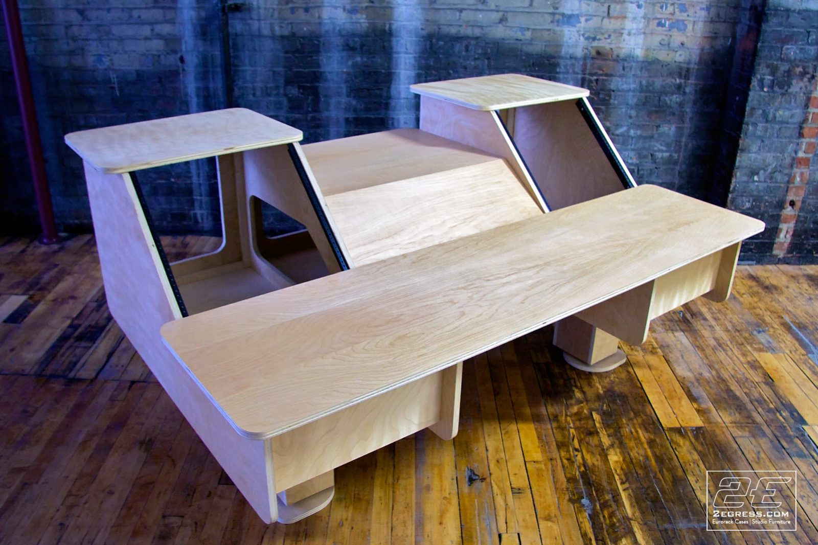 Eclipse Dual Bay desk | angled three-quarter view of the unfinished desk showing the open rack bays | 2Egress