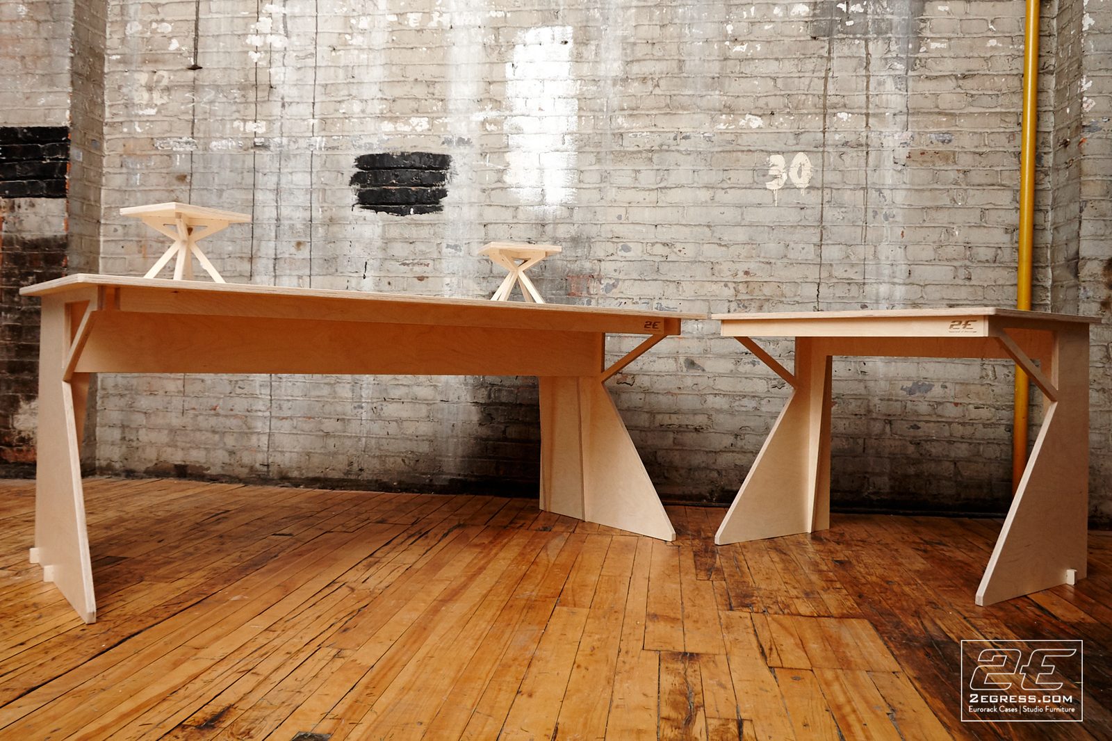 Facet desk | pair of matching desks, side profile view showing the angled leg supports | 2Egress