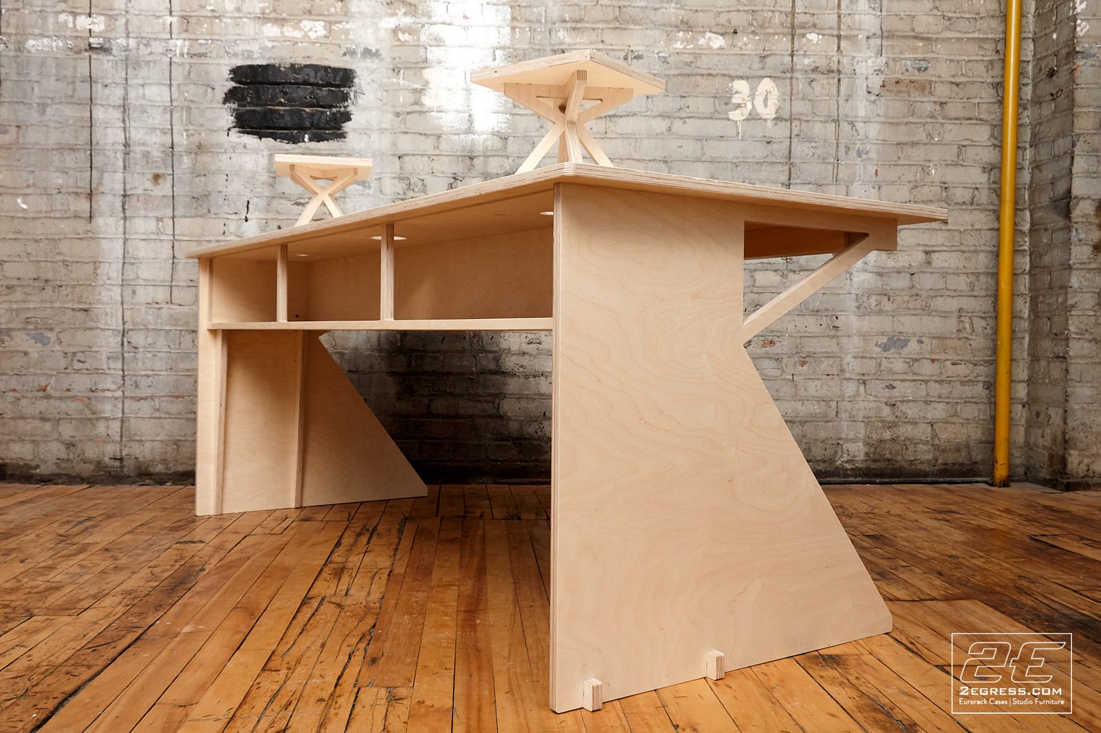 Facet desk | angled three-quarter view showing the underside cubby shelving | 2Egress