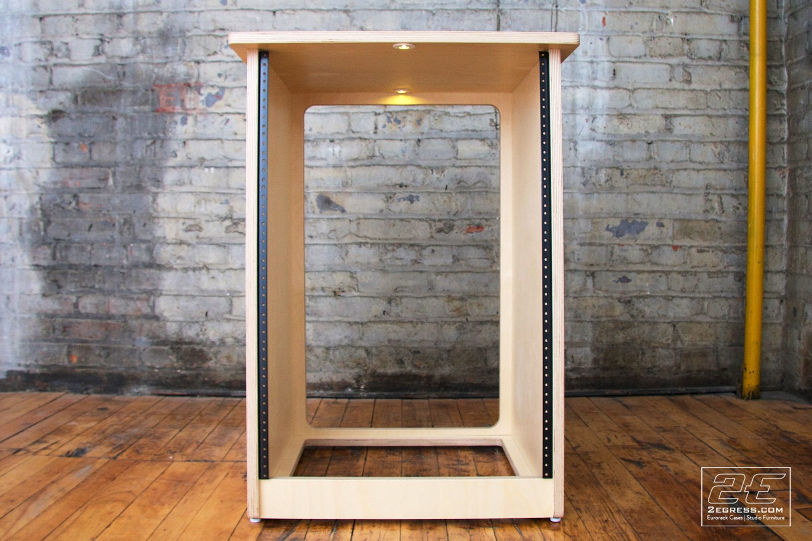 Single Bay Rack | natural birch finish, front view of the taller variant with recessed lighting | 2Egress