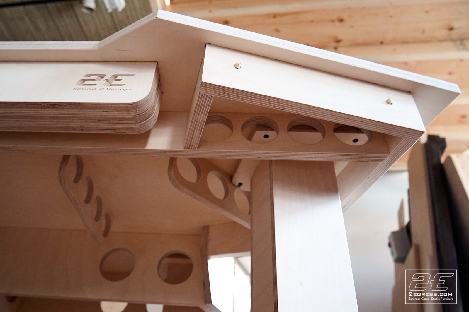 Wing Commander composer desk | underside of wing shelf, engraved 2Egress Sound and Design logo with cable grommet holes | 2Egress