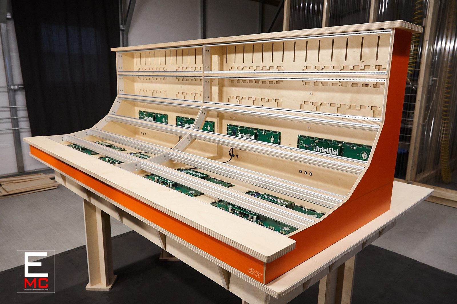 18U Phoenix eurorack case | Three-quarter angle showing the orange side panel and open busboard rows | EurorackModularCase