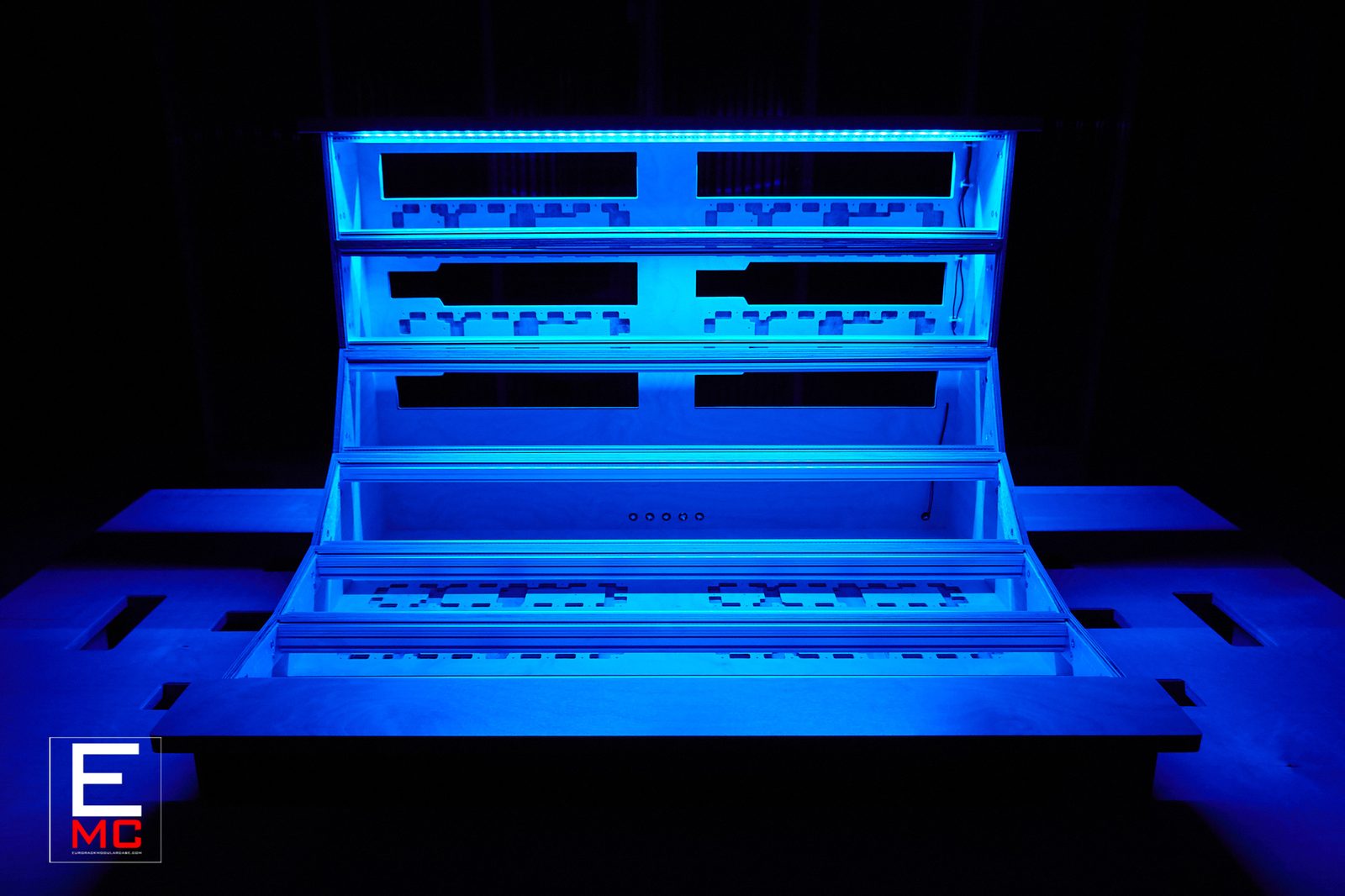18U The Blue eurorack case | Empty case under blue LED lighting, shown resting on shipping pallets before busboard install | EurorackModularCase