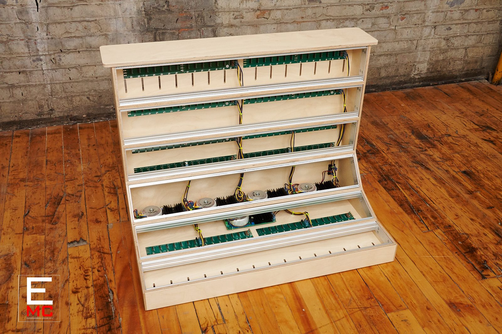 18U Eurorack case | Elevated three-quarter view from the right showing internal power supply with toroidal transformers and heat sinks | EurorackModularCase