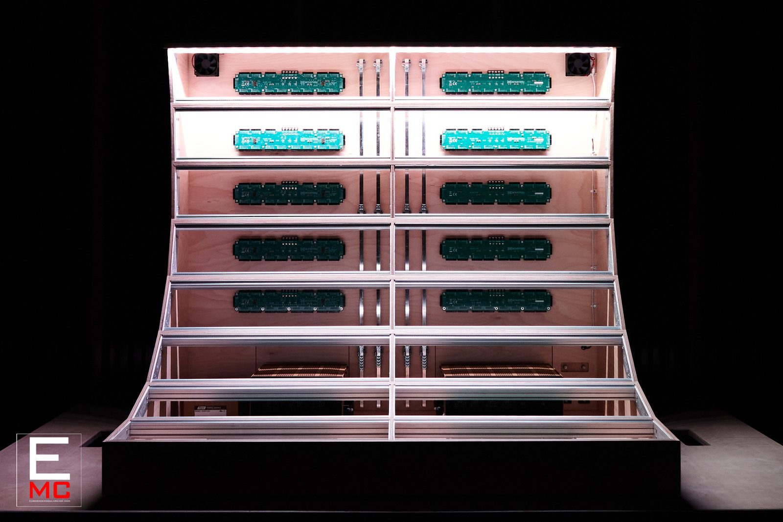24U Barnstormer eurorack case | Front view under pink LED lighting, populated with busboards | EurorackModularCase