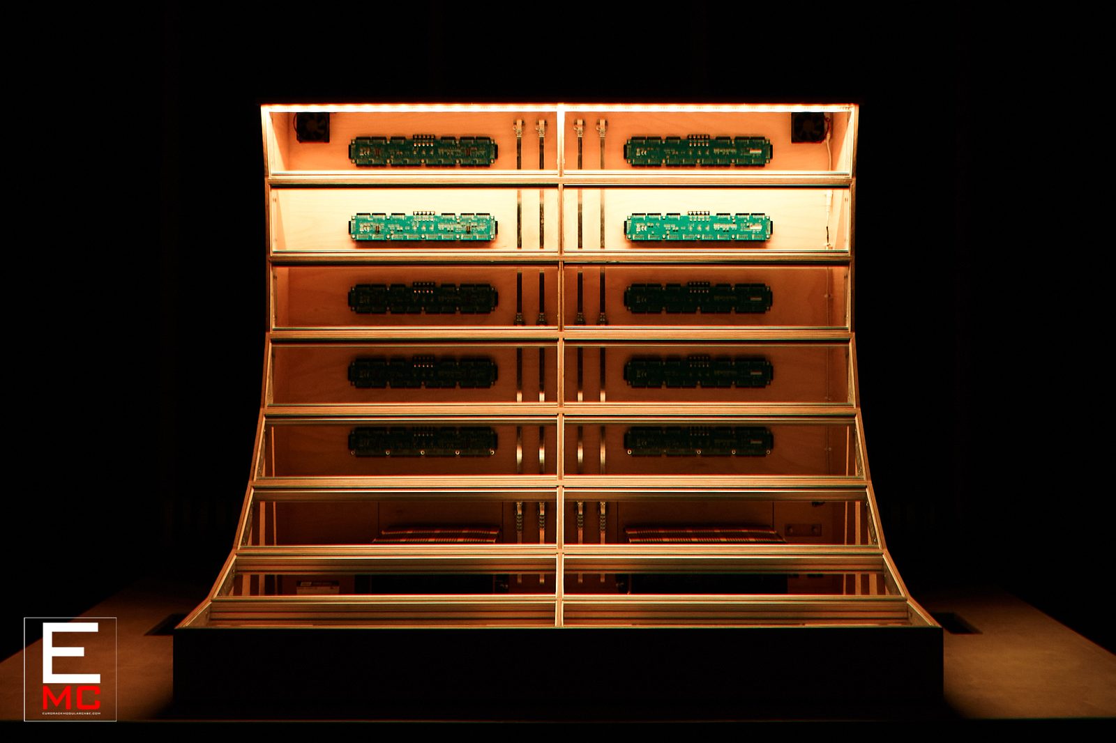 24U Barnstormer eurorack case | Front view under orange mood lighting, populated with busboards | EurorackModularCase
