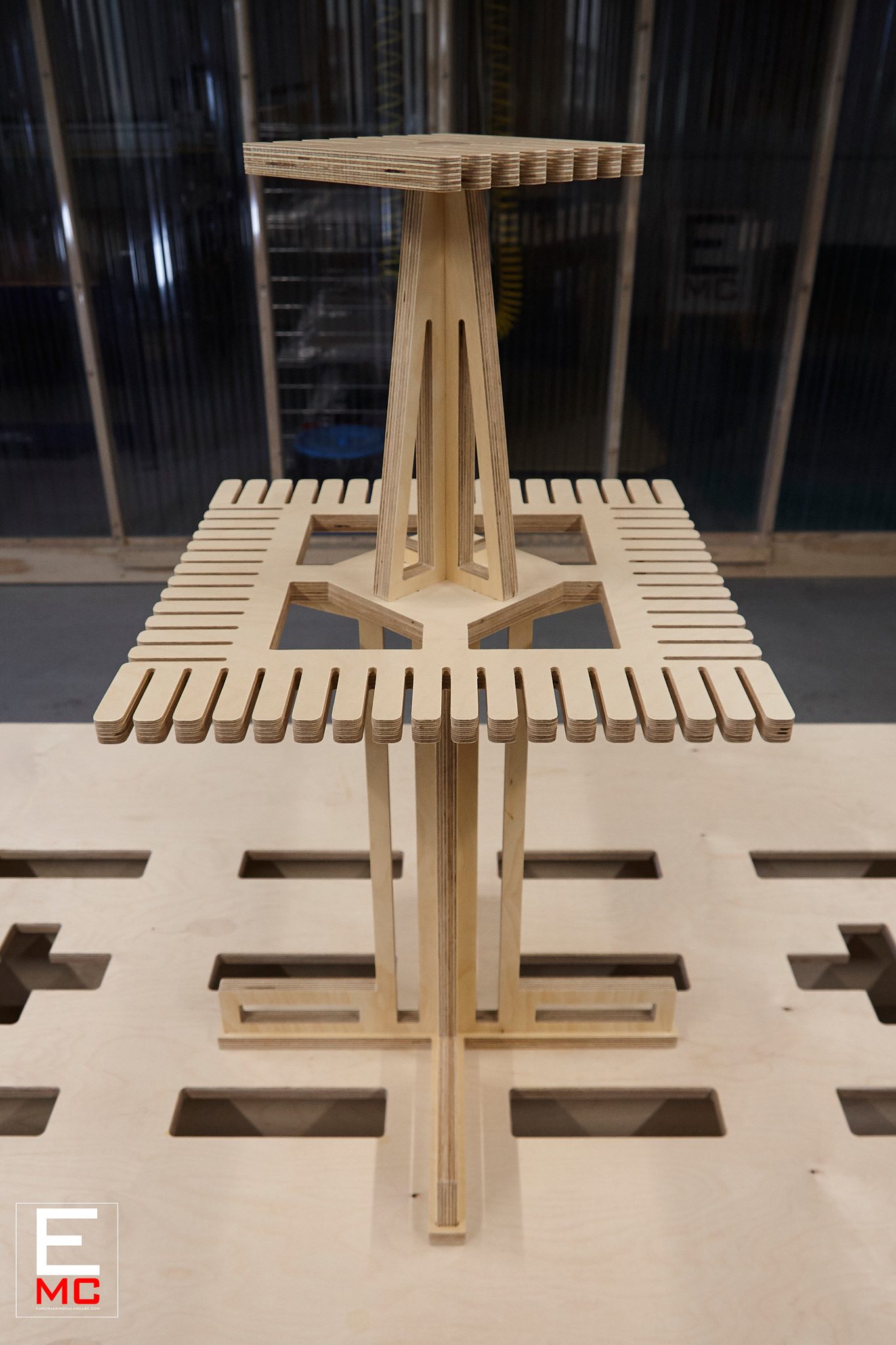 Eurorack Cable Hanger | unloaded, level front view with the workshop's corrugated roll-up doors softly blurred behind it | EurorackModularCase