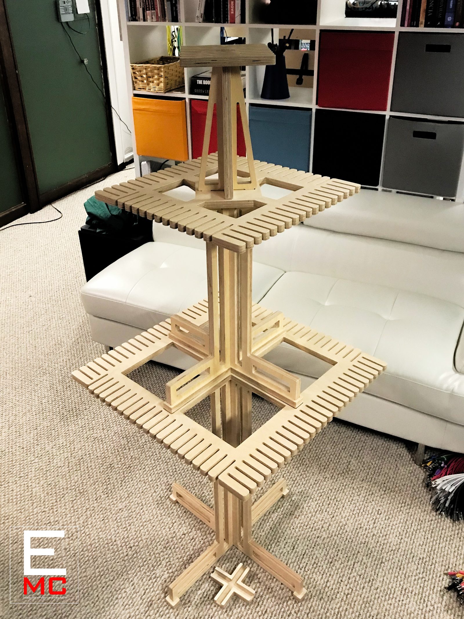Eurorack Cable Hanger | unloaded, standing on carpet in a living room in front of a cubby storage shelf and white leather couch | EurorackModularCase