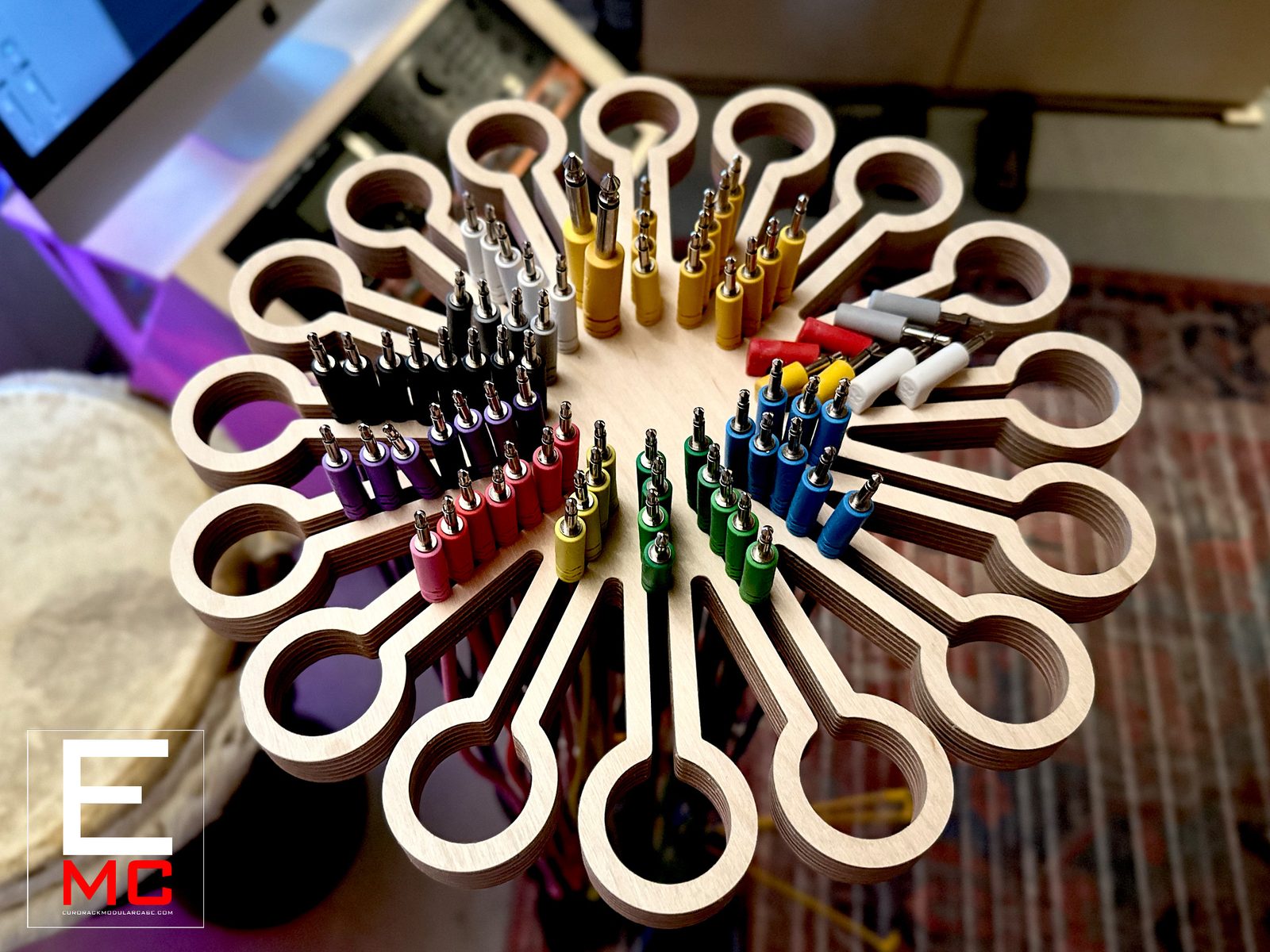 MM160 cable hanger mounted on a mic stand, fully loaded with color-coded patch cables radiating from a 12-arm plywood flower shape | EurorackModularCase