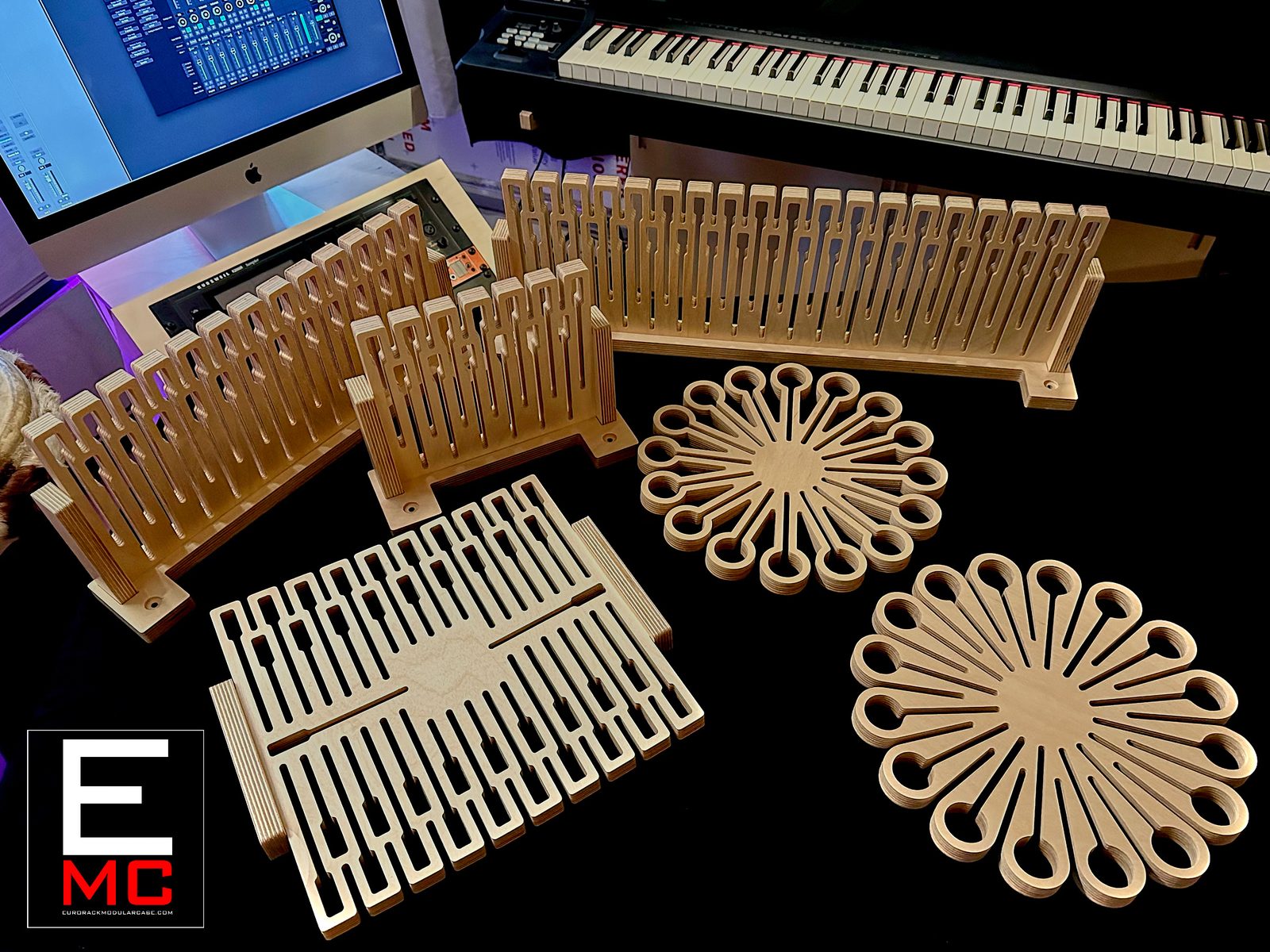 Two unloaded MM-series cable hangers alongside eurorack case rail frames in a studio, monitor and keyboard in the background | EurorackModularCase