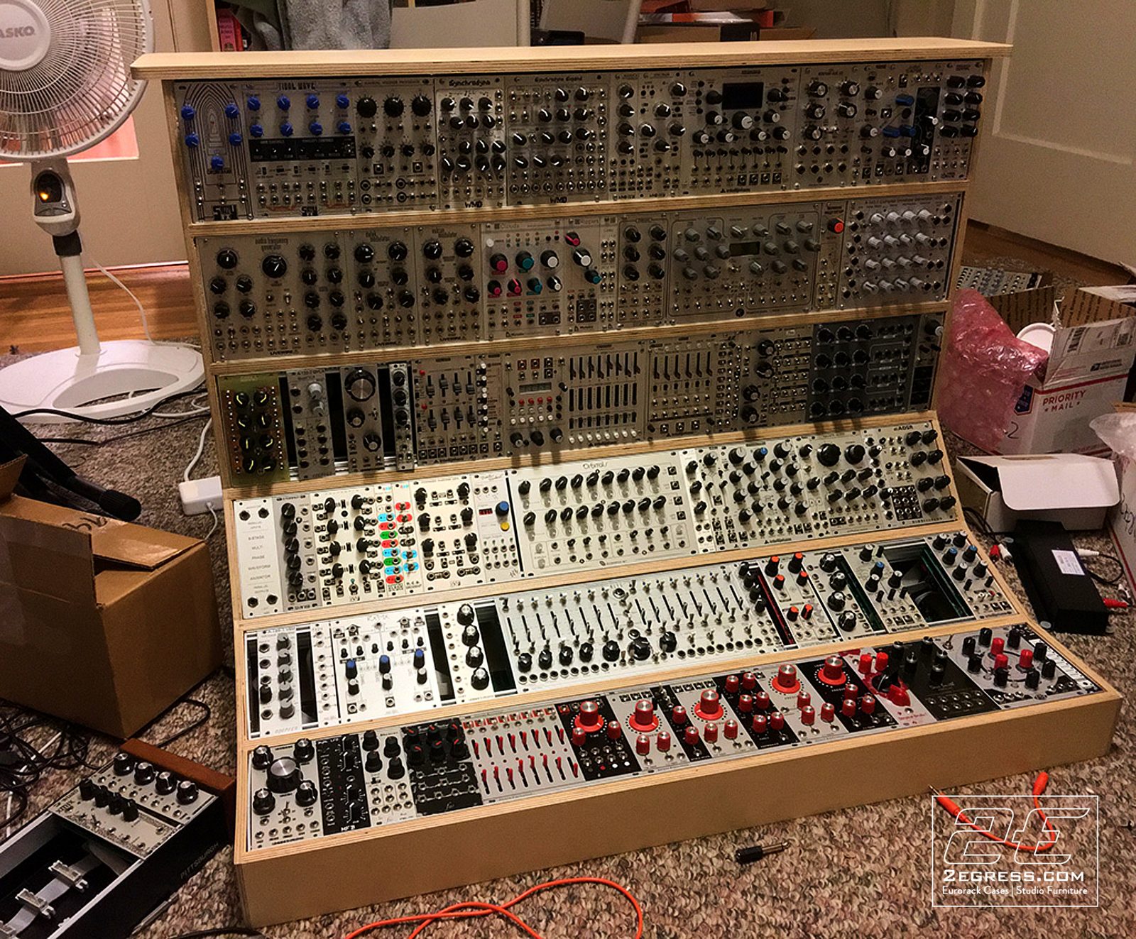 Charles Dworetz | Fully loaded 18U eurorack case packed with modules, photographed at home during setup with moving boxes nearby | Studio Egregia