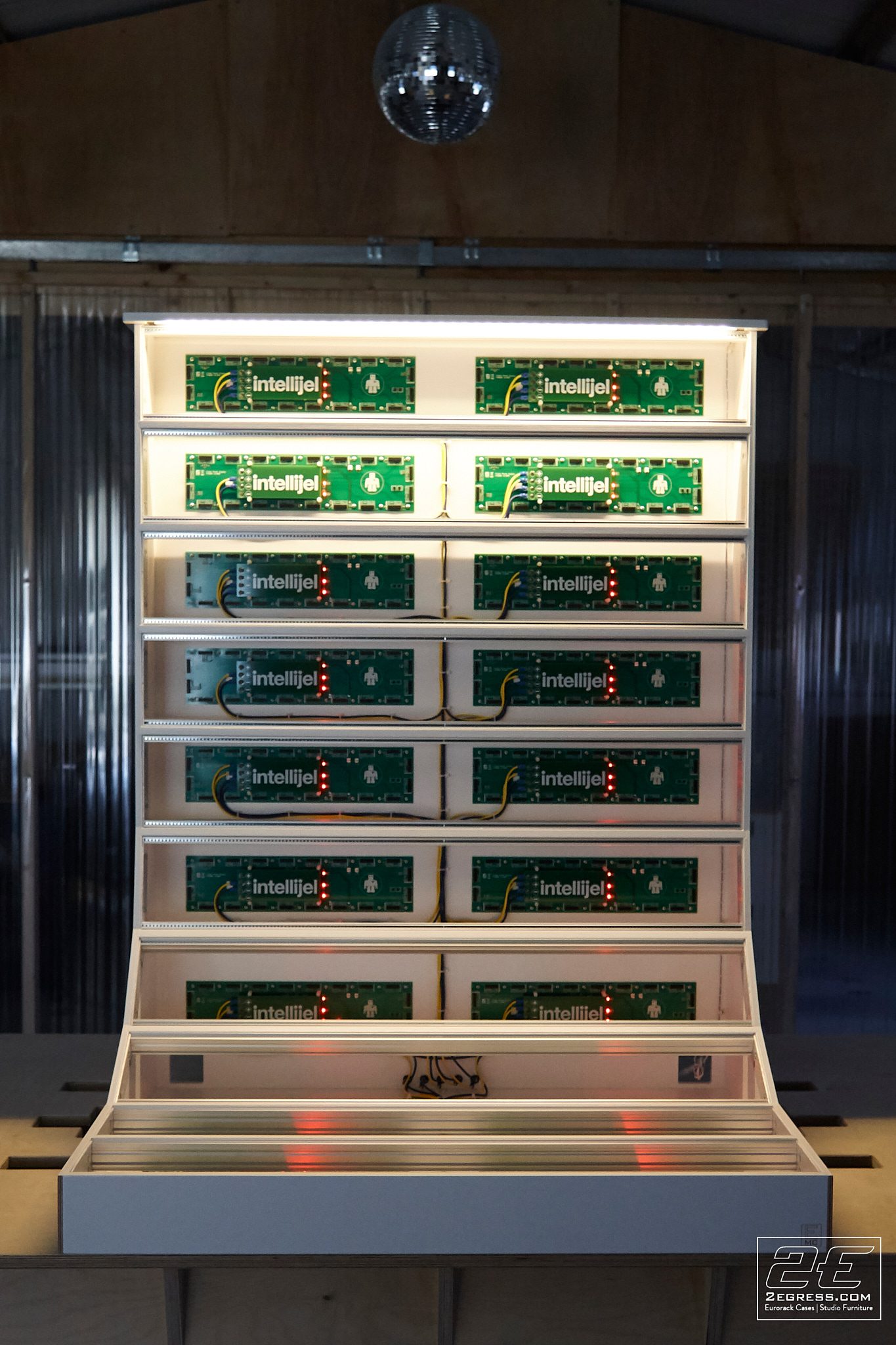 Didier Lean Rachou | 30U 'La Baronesse' case front view with Intellijel power rails and a disco ball overhead | Studio Egregia