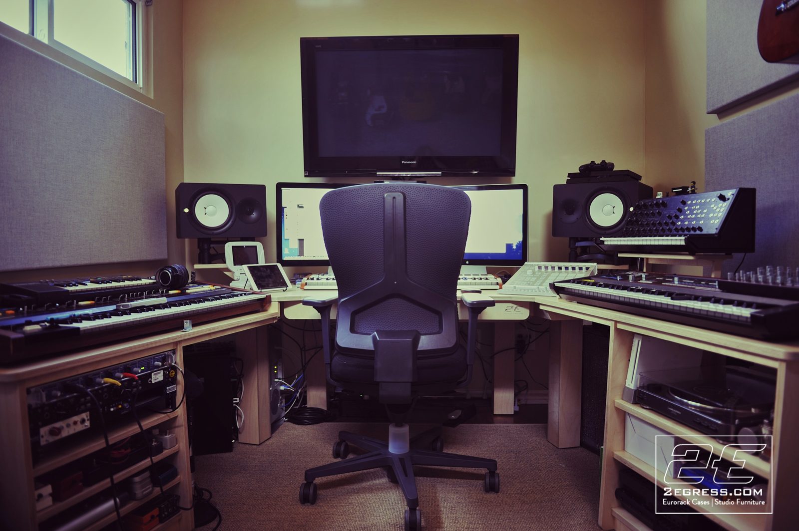 Jim Guthrie | Finished Wing Commander desk viewed from the chair, dual monitors and synths flanking each wing | Studio Egregia