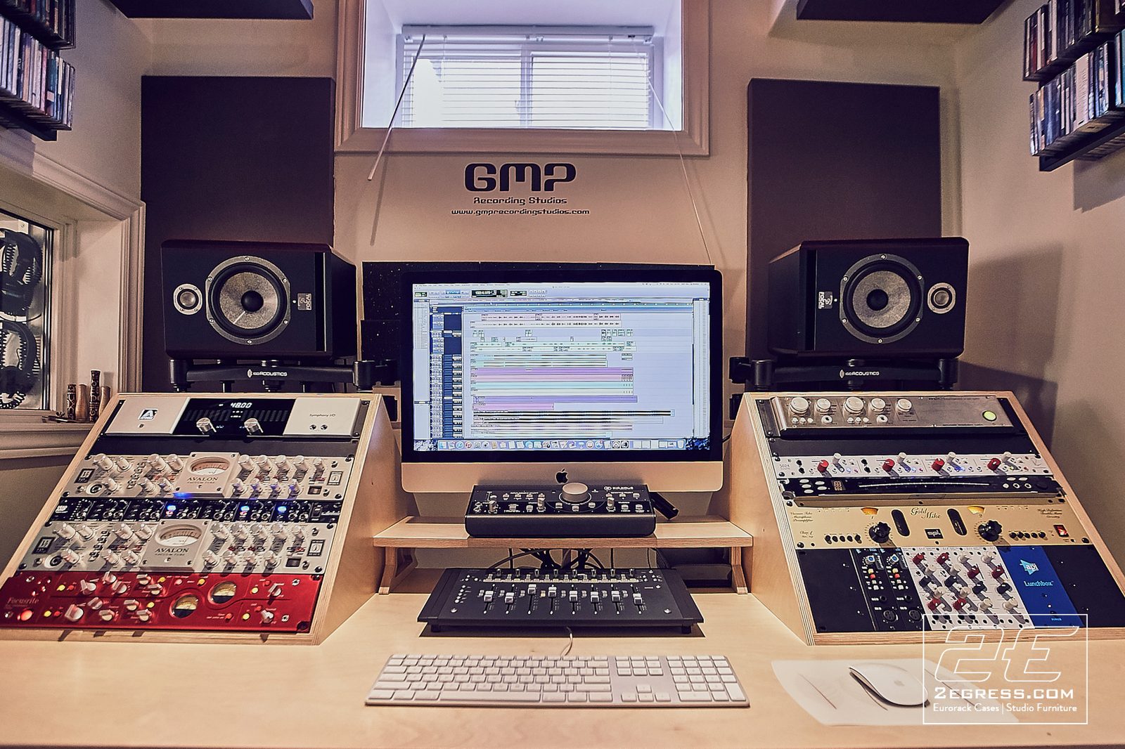 Marito Marques | Wider view of the desk beneath the studio's logo signage with CD racks on the walls | Studio Egregia