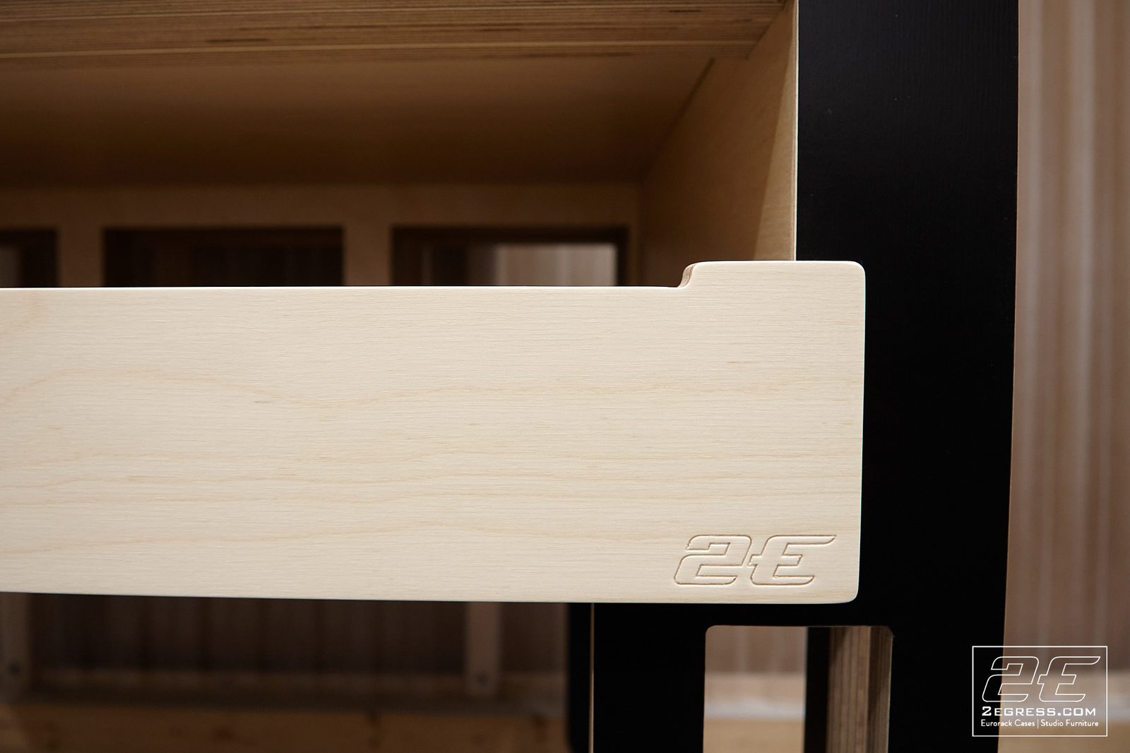 Nate Lueck | Close-up of the maple pull-out drawer's corner with engraved 2E logo | Studio Egregia