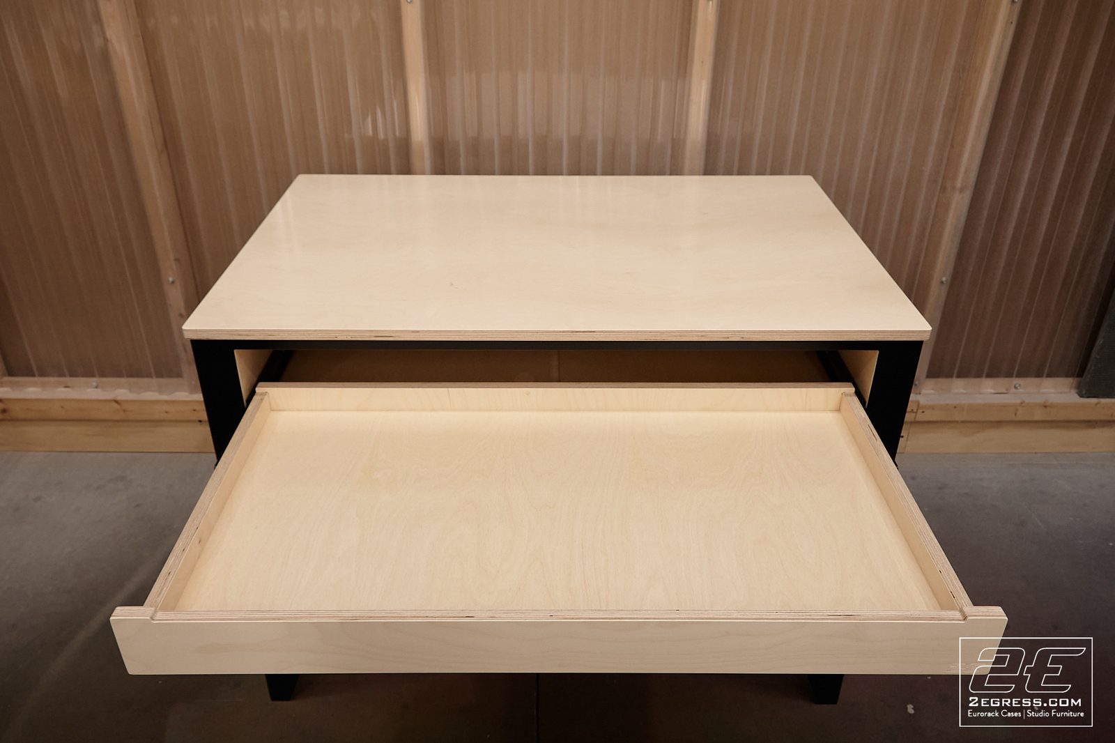 Nate Lueck | Front view of the case with the pull-out drawer open and empty in the workshop | Studio Egregia