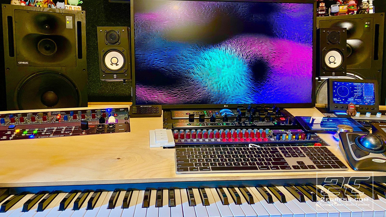 Neil Parfitt | Front angle of the VTOL desk showing the mixing surface, keyboard, and colorful monitor screensaver | Studio Egregia