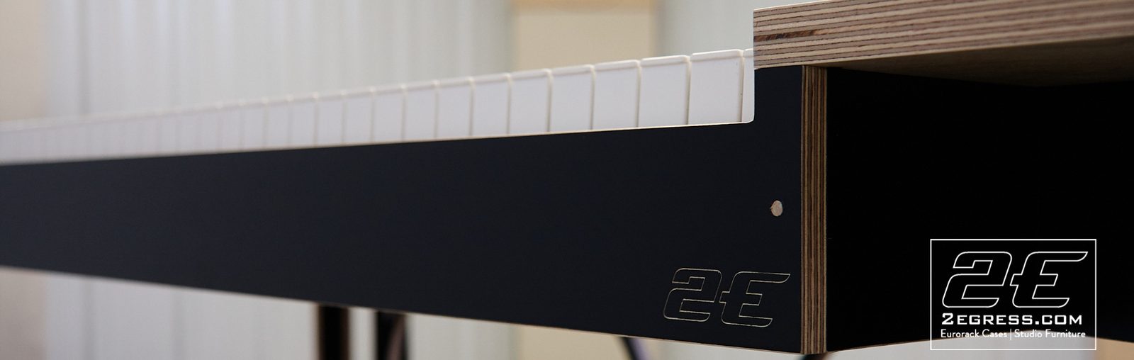 Rich Walters | Close-up of the Luna desk's black edge detailing and engraved 2Egress logo | Studio Egregia